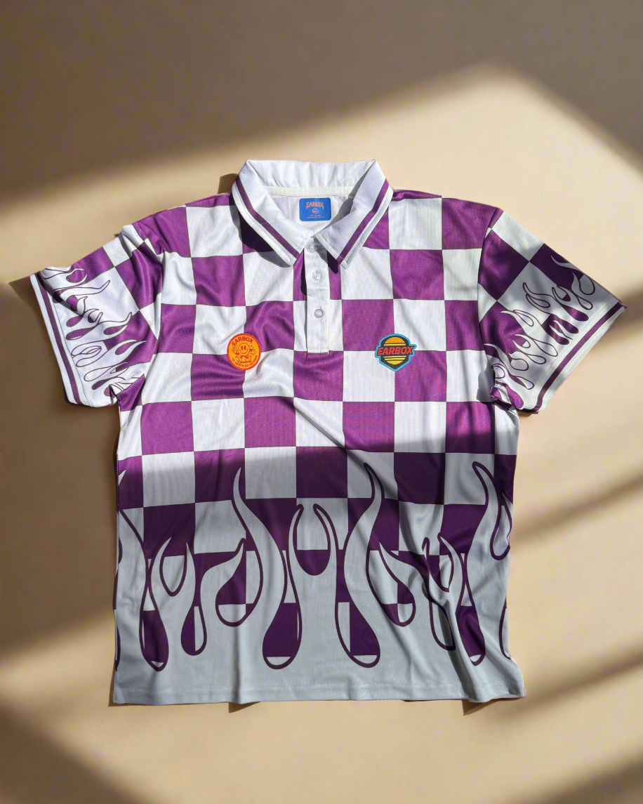 Checkered shirt with purple flames and logo on a wooden surface